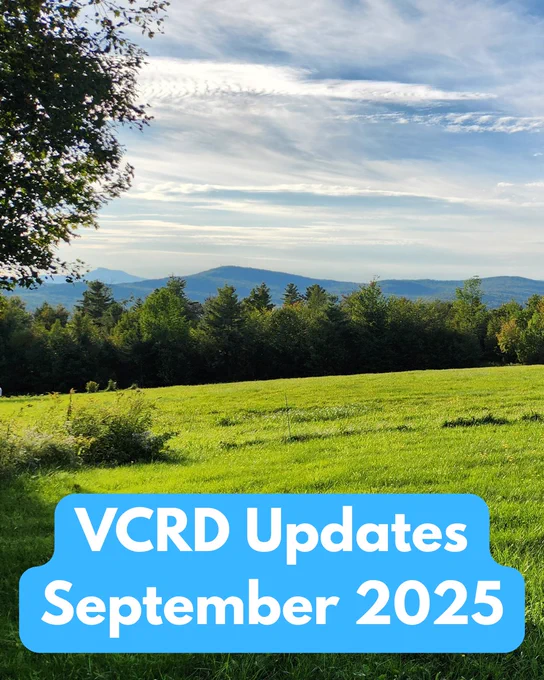 A landscape with mountains in the distance with green grass and a blue sky with the words VCRD Updates September 2025