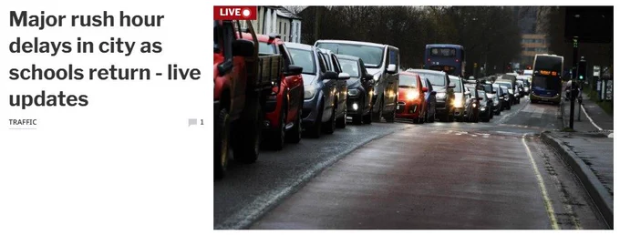 A line of cars and vans stuck in a jam. And a bus moving along a clear bus lane.