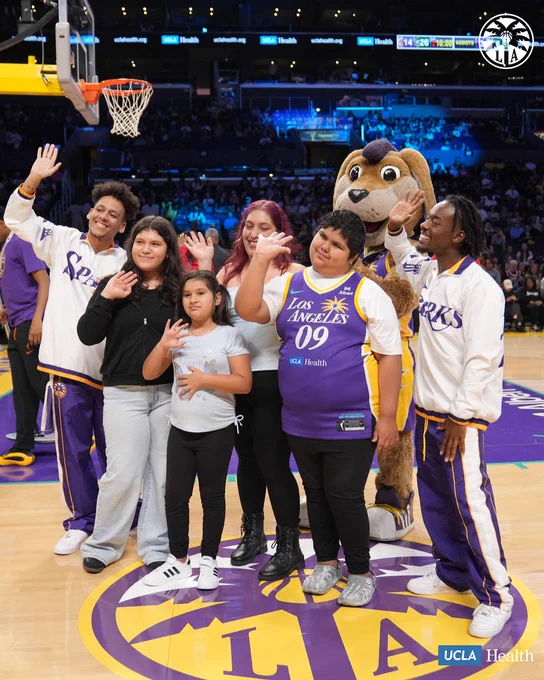 Bella's family, Sparks Crew, & Sparky being recognized on court 
