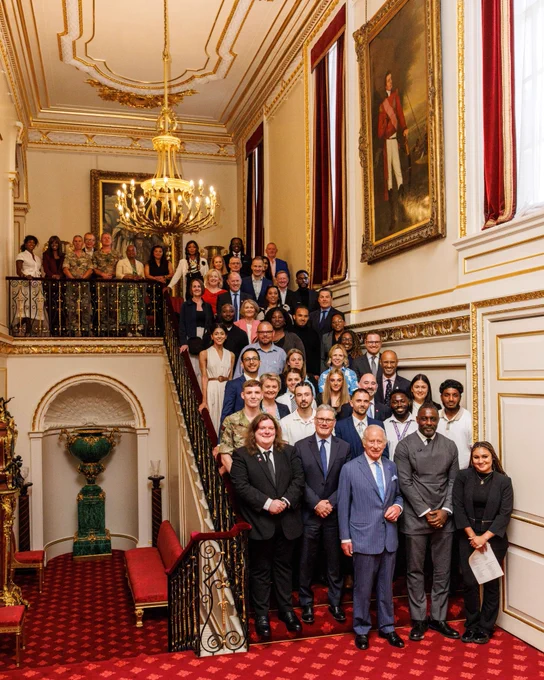 Image shows His Majesty The King on a staircase with all those who attended a Youth Opportunity Summit in July.