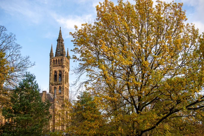 University of Glasgow Gilbert Scott building with trees in front of the building 