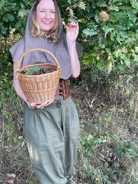 me in a frankly bonkers medieval outfit in teh woods wiht a basket full of galls