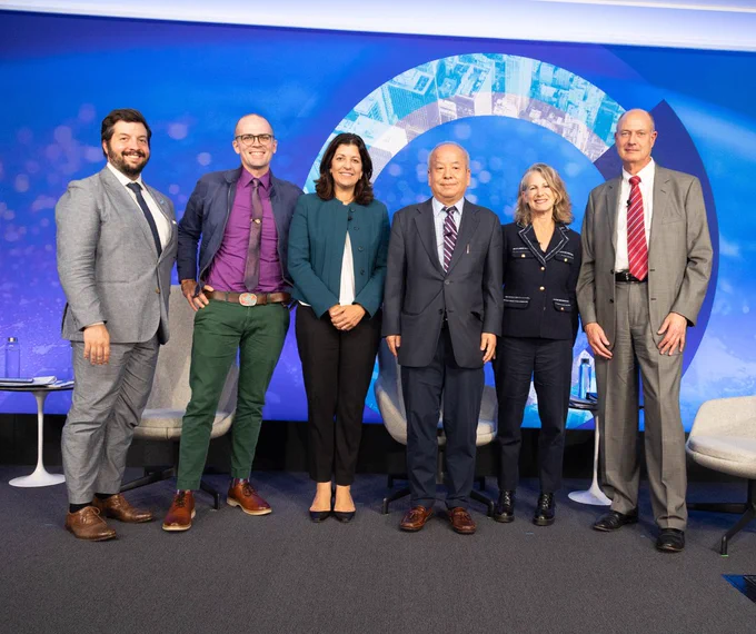 The panelists pose for a photo onstage at the Chicago Council Conference Center.