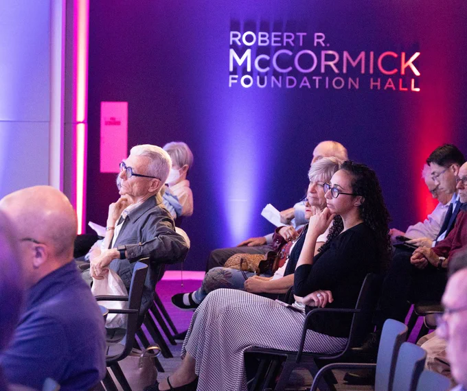 Audience members watching the program.