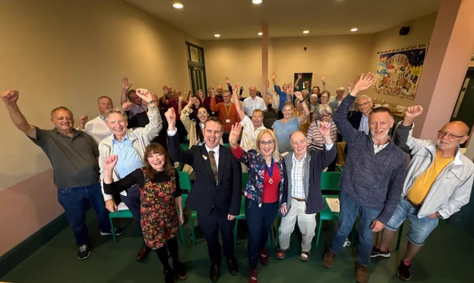 Attendees at the Friend of Parks celebration event stood up waving their hands
