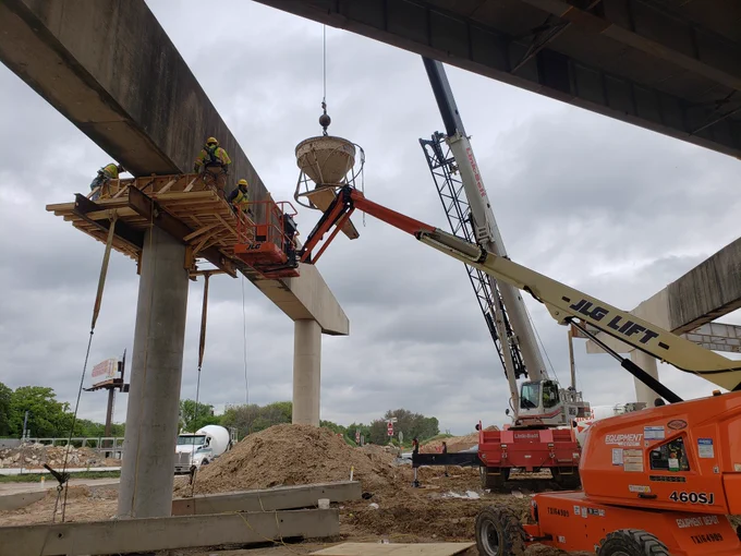 cranes and lifts maneuver heavy materials 