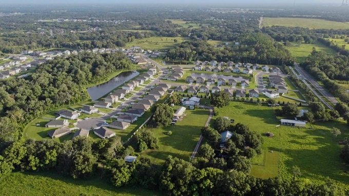 A peaceful neighborhood nestled among trees and ponds