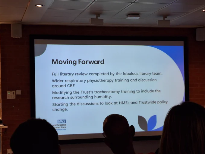 The image is a photo of a slide from a presentation about a research project. As part of moving forward, a full literary review was completed by the fabulous library team.
