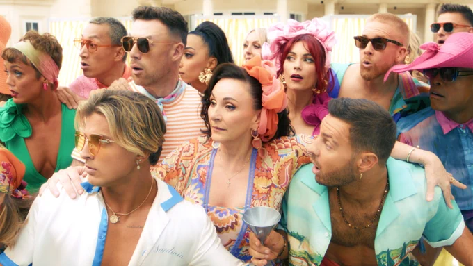 The Strictly professional dancers and Head Judge Shirley Ballas stand together at a pool party, looking shocked by something off screen.