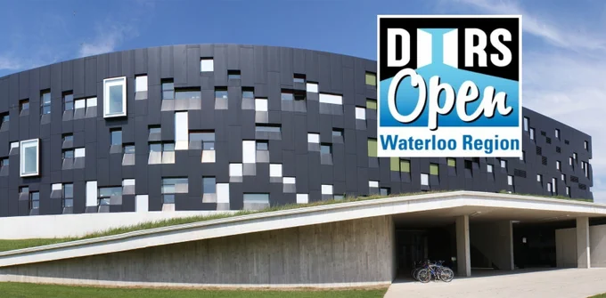 The long, dark Perimeter Institute building in Waterloo, with randomly-arranged windows and a blue sky behind. "Doors Open Waterloo Region" logo graphic on top.