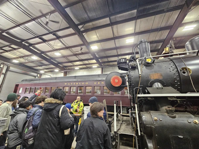 Visitors look at an old train at the Waterloo Central Railway Restoration & Maintenance Facility.
