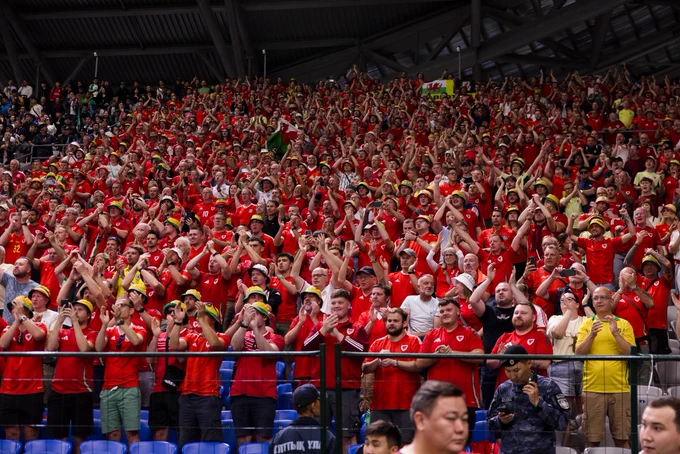 The Red Wall applaud Cymru players.