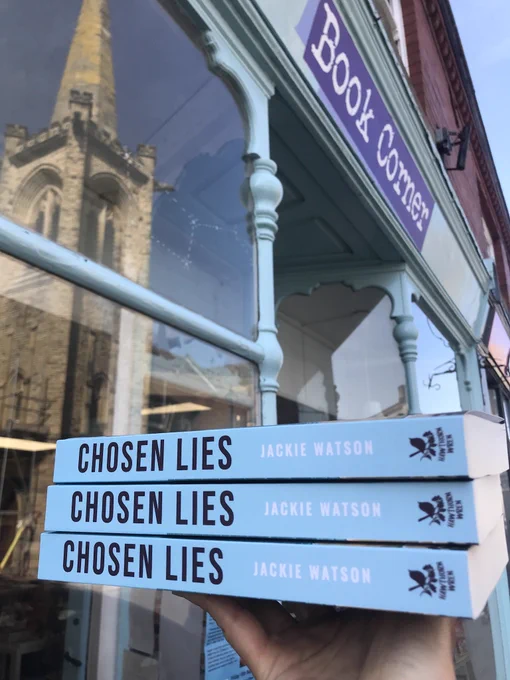 Chosen Lies by Jackie Watson held up in front of Book Corner, Saltburn-by-the-se