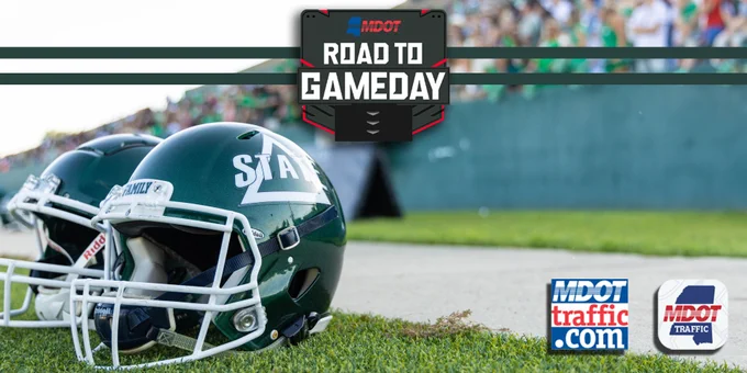 Two Delta State football helmets on grass with MDOT's "Road to Gameday" logo, along with the MDOT Traffic app and MDOTtraffic.com logos.