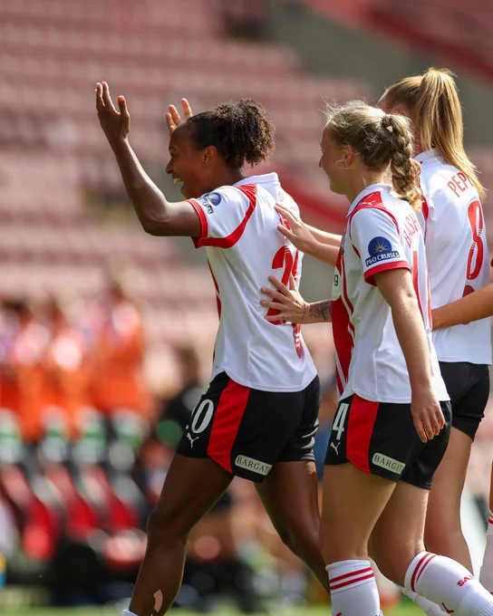 Atlanta Primus celebrates scoring against Ipswich Town at St Mary's Stadium in the red and white home kit