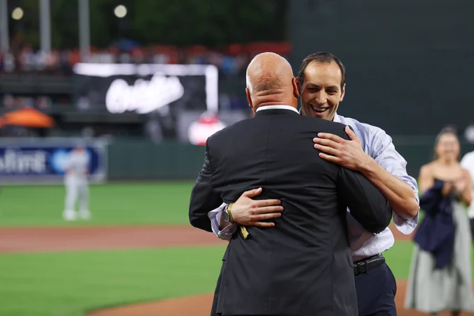 Ryan Ripken and Cal Ripken, Jr. embrace.