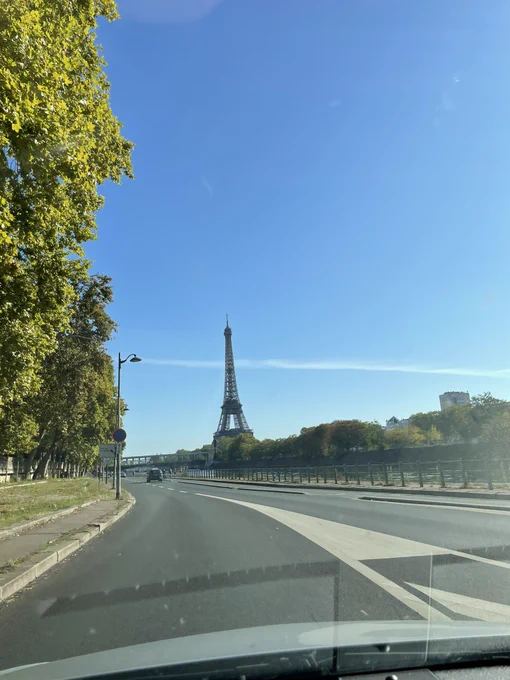 A view out of the frontshield of the car with the Eiffel Tower in sight