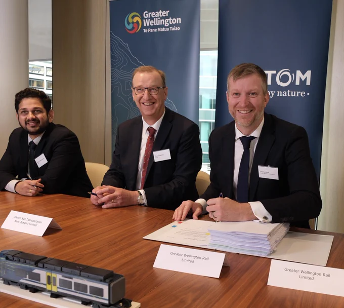 Me signing the contract for new trains with Alstom representatives in Wellington.