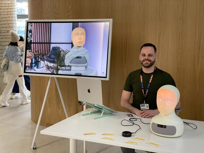 Shaul Ashkenazi of the UKRI Centre for Doctoral Training in Socially Intelligent Artificial Agents and the Furhat robot used in the project.