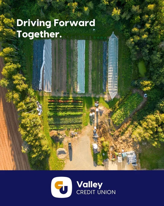 Arial photo of a rural farm in Nova Scotia with a garden, field, and construction for a greenhouse.