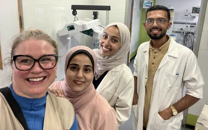 A photograph of a group of physiotherapists looking at the camera smiling