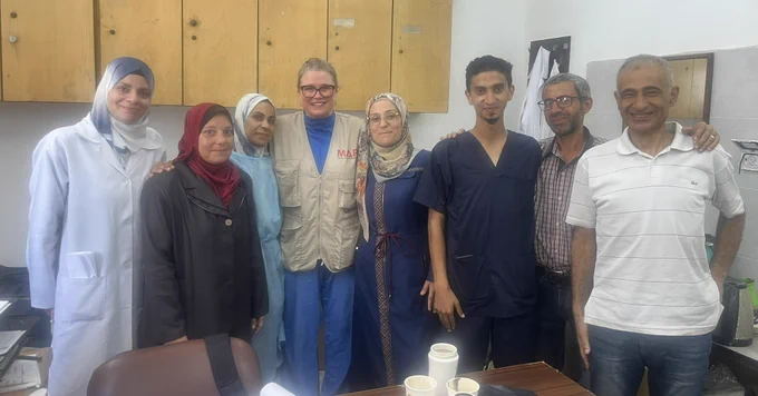 A photograph of a group of physiotherapists looking at the camera smiling