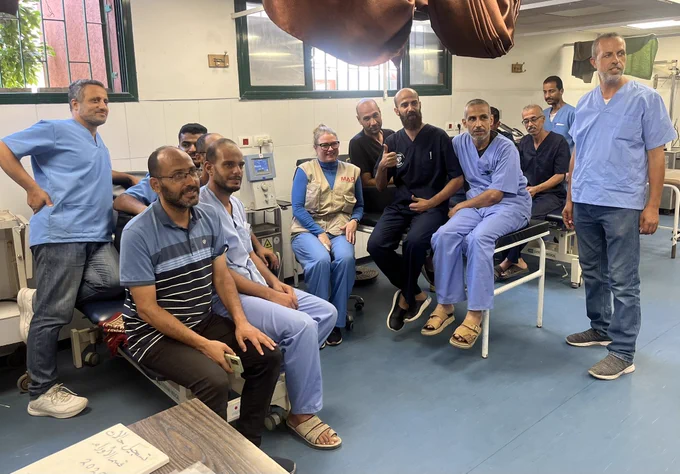 A photograph of a group of physiotherapists looking at the camera smiling