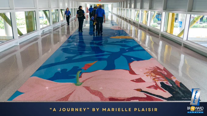 “A Journey” by Marielle Plaisir. FLL employees walking across the connector bridge over the terrazzo floor art. 