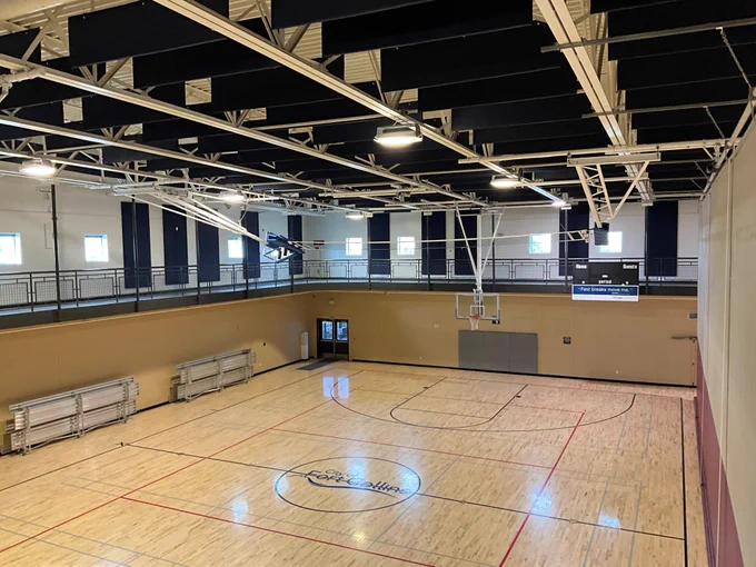 An indoor recreation gym with the City of Fort Collins logo on the floor