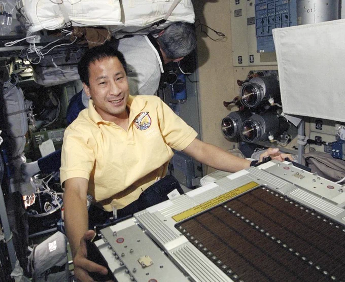 Astronaut Edward T. Lu, mission specialist, handles part of the treadmill device on the Service Module for the International Space Station. The crew left this and a large number of other items of hardware and supplies for future inhabitants of the station. More than three tons of equipment were delivered to space station. Credit: NASA