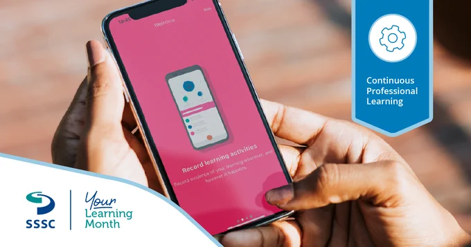 Close-up of a hand holding a smartphone displaying a pink screen with MyLearning app for recording learning activities.