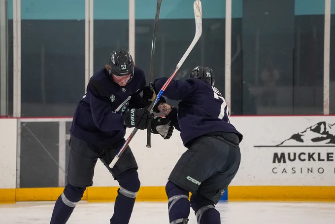 Photo of Ty Nelson and Blake Fiddler play fighting during practice.