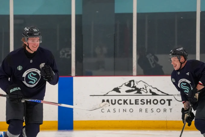 Photo of Ty Nelson and Blake Fiddler laughing after play fighting during practice.