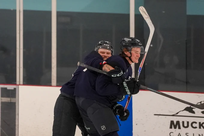 Photo of Ty Nelson and Blake Fiddler play fighting during practice.