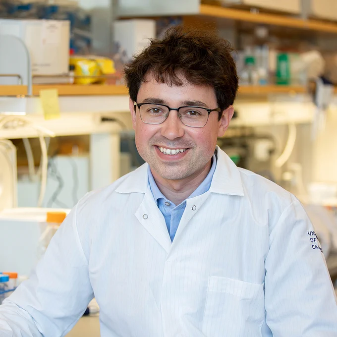 UCSF neuroscientist Tomasz Nowakowski, PhD, seated at a bench in his lab.