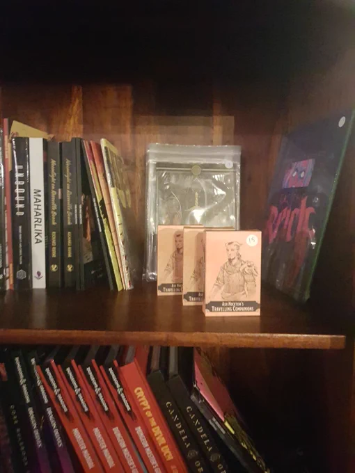 Shelves showing RPGs and a deck of NPC cards called Ash Nocktem's Travelling Companions.