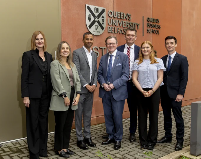 Image shows (L-R): Sonia O'Hare, School Manager, Queen's Business School; Desiree Dusseault, MBA student at Queen's Business School; Professor M. N. Ravishankar, Dean and Head of Queen's Business School; Professor Sir Ian Greer, President and Vice-Chancellor of Queen's University Belfast; Professor Richard Miles, Provost and Deputy Vice-Chancellor of Queen's University Belfast; Róise Robinson, Queen's Business School Graduate; and Dr Alan Hanna, Director of Accreditation, Queen's Business School. They are pictured outside the Business School's Student Hub.