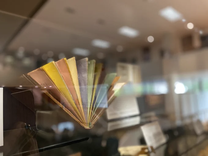An image of a book with multicoloured pages open on display.