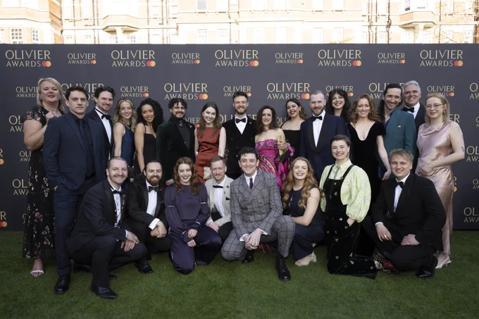 Cast and creatives from The Curious Case Of Benjamin Button posing at the Olivier Awards event, dressed in formal attire.