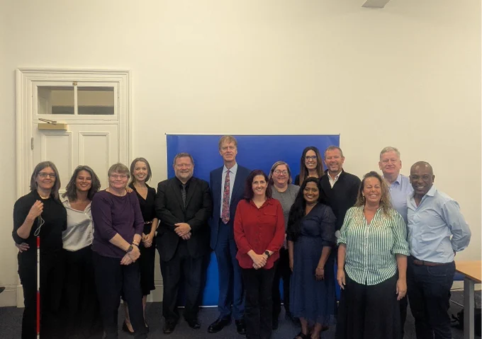 The Minister for Social Security and Disability, Stephen Timms MP, stands with the Co-Chairs and members of the BSL Advisory Board. 