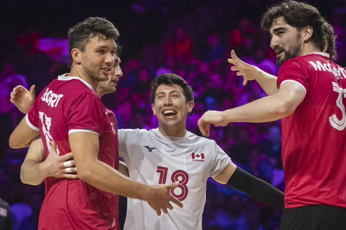 Team Canada men's volleyball players celebrating a point.
