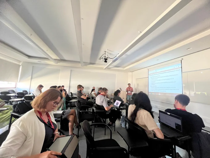 A classroom with me presenting my research “Uses of Email Applications by People who are Blind and Visually Impaired”