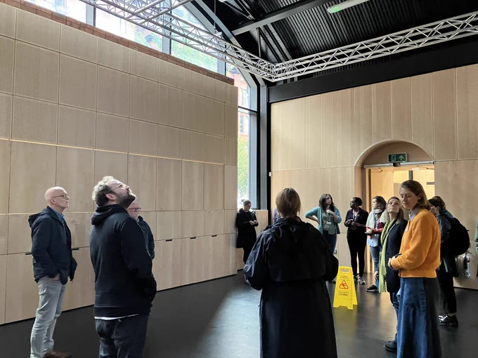 Group of people having a guided tour around HOME Arches