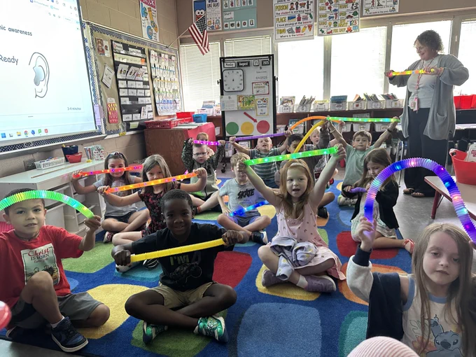 first graders in burnette's class use stretchy tubes to sound out words