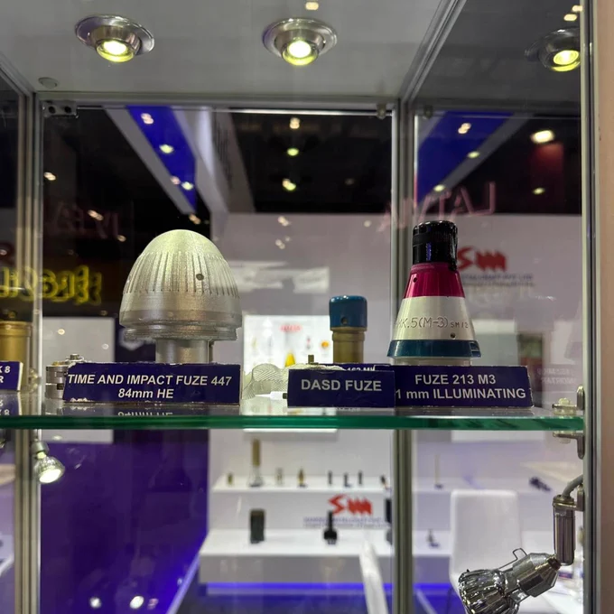 Display case showing DASD fuze, used to make cluster munitions work.