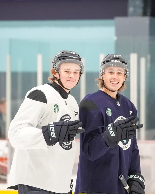 Photo of Fidds and Will Reynolds throwing up peace signs and smiling during practice at Rookie Camp.