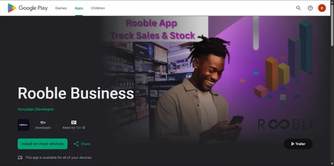 A liquor store owner uses the Rooble Business app on his phone to check reports.