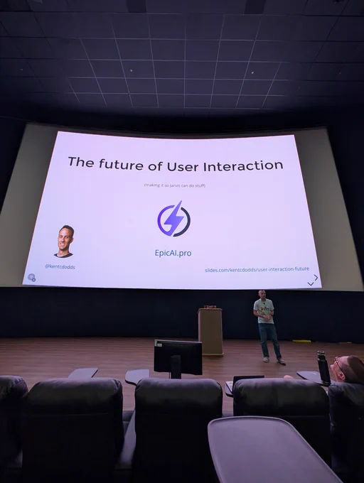 Kent C. Dodds on stage at UtahJS in front of the big screen with his talk intro slide on display 