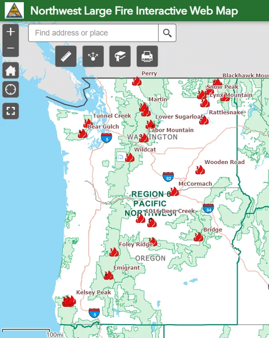Colored map of Pacific Northwest uses red flame graphics to indicate numerous wildfire locations; large text at top reads 'Northwest Large Fire Interactive Web Map.'