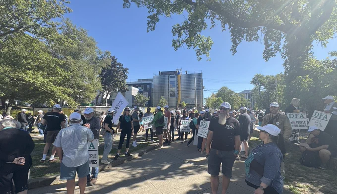 Photo of a crowd of picketers forming up near campus